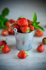 red ripe natural strawberries on a wooden table
