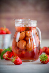 Sweet refreshing berry compote of ripe strawberries in a decanter
