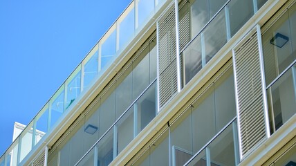 Obraz premium Fragment of modern luxury residential apartment, home house building concept. Modern apartment building on a sunny day with a blue sky.
