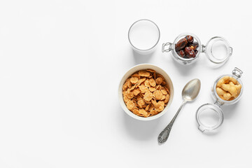Composition with tasty corn flakes and milk on light background