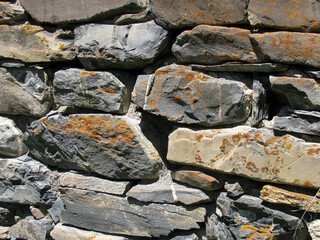 The background is the ancient masonry of the tower.