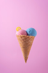 ice cream in waffle cone on pink background minimalistic concept
