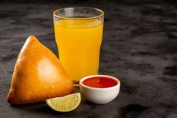 Arabic meat sfiha with juice cop on the table.