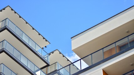 Fragment of modern luxury residential apartment,  home house building concept. Modern apartment building on a sunny day with a blue sky.