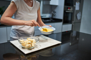 Obraz na płótnie Canvas Woman whisking eggs for a banana pancake recipe