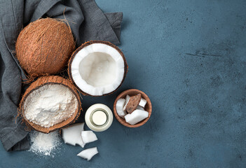 Coconut milk, flour and coconuts on a dark background.