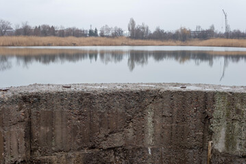 round concrete spillway of a dry lake. Climate change in Ukraine