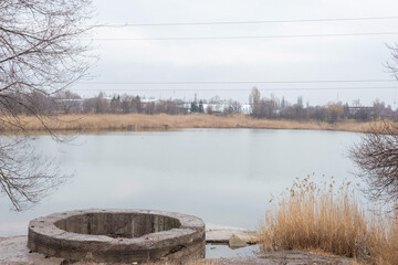 round concrete spillway of a dry lake. Climate change in Ukraine