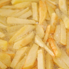 Deep-fried French fries, deep-fried potatoes. Hot frying oil.