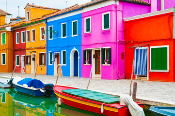 Fototapeta na wymiar Colorful houses on the canal in Burano island, Venice, Italy. Famous travel destination.