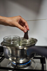 Close-up of a woman's hands making chocolate in a bain-marie