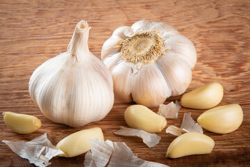 Garlic Cloves and Bulb isolated on wooden background.