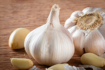 Garlic Cloves and Bulb isolated on wooden background.