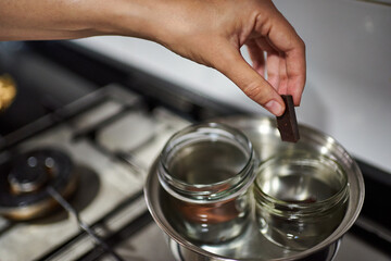 Close-up of a woman's hands making chocolate in a bain-marie
