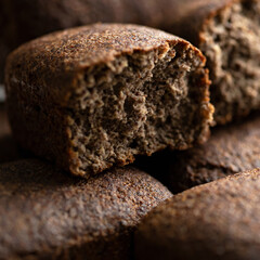Loaf of wholemeal rye bread. Healthy brown grain bread. Fresh baked goods concept. Soft focus. Close up shot.