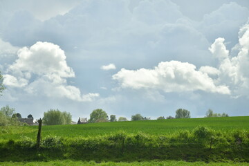 Cumulus blancs sous un cumulonimbus d'orage au dessus de la campagne &agrave; Ecaussinnes en Hainaut 