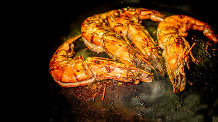 Grilled prawn on a dark background. Seafood appetizer.