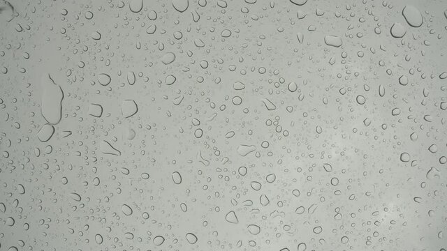  Water drop on clear glass of moon roof of vehicle, natrual background