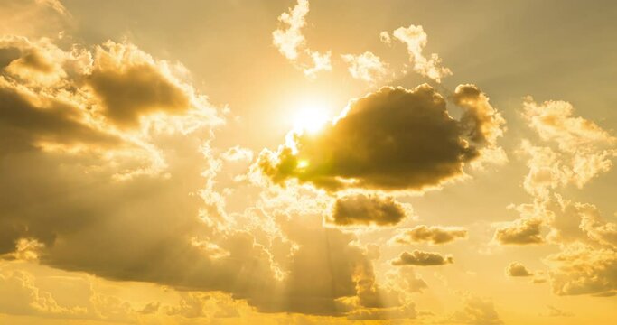 Top view timelapse of yellow orange sunny sky with bright sun and rays at hot summer. Vibrant sunlight sunbeam and flares with cumulus clouds. Cloudscape time lapse. 4k raw B-roll footage. Clean.