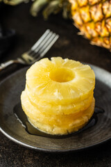 Canned sliced pineapple fruit on plate.
