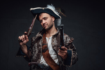 Cool pirate with handguns against dark background