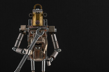 Fototapeta premium Steampunk robot holding wrench. Chrome and bronze parts.
