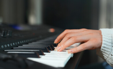 Fototapeta na wymiar Girl playing piano. Close-up view.