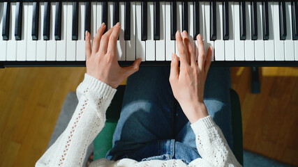 Girl playing the piano. Top view.