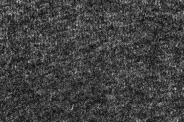 Fototapeta premium Woolen knitted black texture background, warm cloth textile material close-up photo