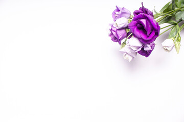 A bouquet of purple roses looks out from the top corner of the card.