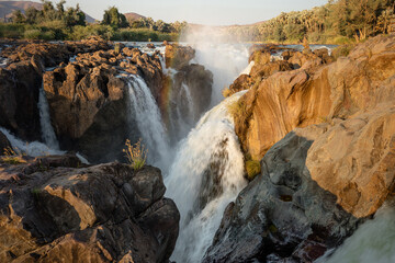 Close up of multiple cascading rivulets of the Epupa falls, Kunene river, on the Namibia, Angola border in the Kaokoveld region of Namibia.  A moderate shutter speed largely freezes water motion - obrazy, fototapety, plakaty