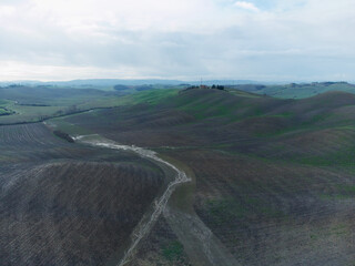 Siena, Tuscany - November 10 2020: Autumn colors in the Tuscan hills between vineyards and green...
