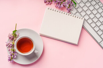 Trendy workspace design with colors, keyboard on pink background top view. Space for text in a notepad for writing