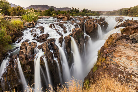 Epupa falls, Namibian side, Angola border.  Multiple rivulets and cascading waters in soft evening light, with slow shutter speed giving a smooth, restful feel to this image