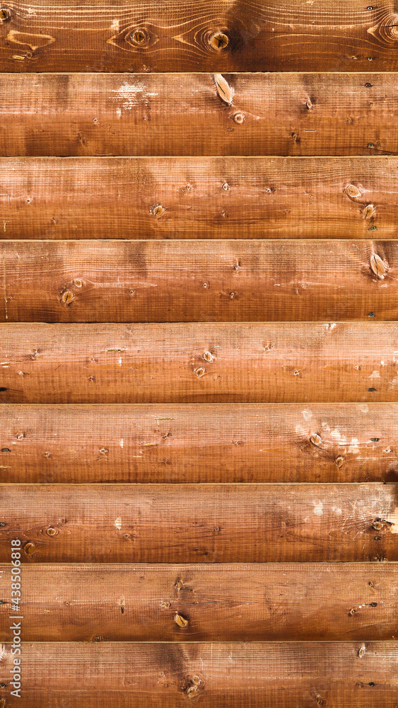 Wall mural texture of the old varnished wooden panels screwed to the wall as a background.