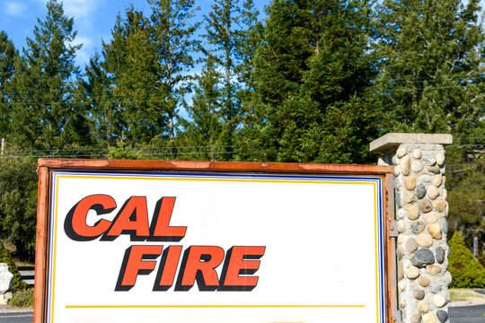 CAL FIRE sign at fire station. Green tree forest background. - Santa Cruz, California, USA - 2021