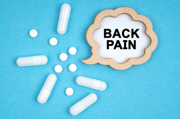 On a blue background, pills and a plate, inside which the inscription - BACK PAIN