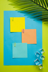 Tropical green background with exotic tropical palm leaf. Ice cubes. Blank colorful cards with space for text, Minimal summer concept, work motivation. escape from the office, integration trip, Flat