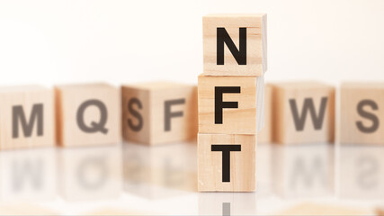 word nft from wooden blocks with letters, concept