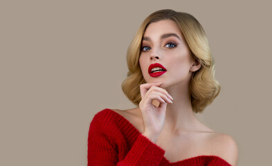 Portrait of beautiful young woman wearing red sweater with perfect young skin and professional...
