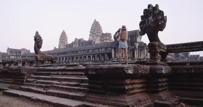 A Wide-Angle Shot of a Person Taking Pictures of a Magnificent Temple