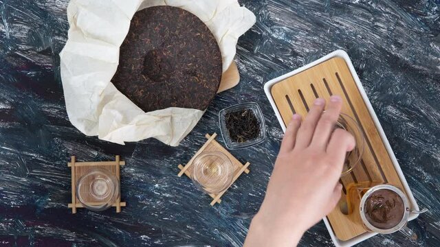 Tea ceremony with Chinese puer tea, top view. Dark background