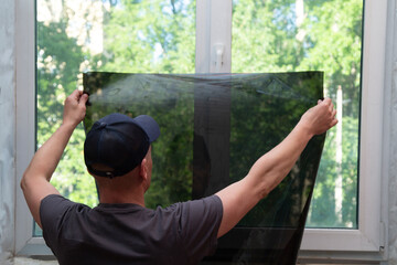 Installation of window film in the office. Protection from ultraviolet radiation.