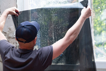 Installation of window film in the office. Protection from ultraviolet radiation.