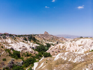 Fototapeta na wymiar Aerial view of Uchisar Castle, near Goreme, Turkey. It is a huge tuff peak perforated by a thousand cavities. It is a settlement in Cappadocia, in the Nevşehir province 