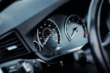 Modern car mileage speedometer. Vehicle interior details.