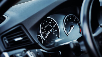 Close up shot of a speedometer in a car. Car dashboard. Car instrument panel. Speedometer, tachometer, odometer.