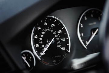 Car instrument panel. Dashboard closeup with speedometer and tachometer.