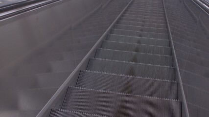 Escalator step movement. Automatic transportation of passengers to floor levels. Stiffening ribs of a metal structure.