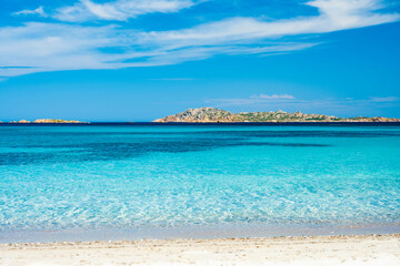 Stunning view of a turquoise sea whit a small island in the distance. Romazzino Beach, Costa Smeralda, Sardinia, Italy. Natural background with copy space.